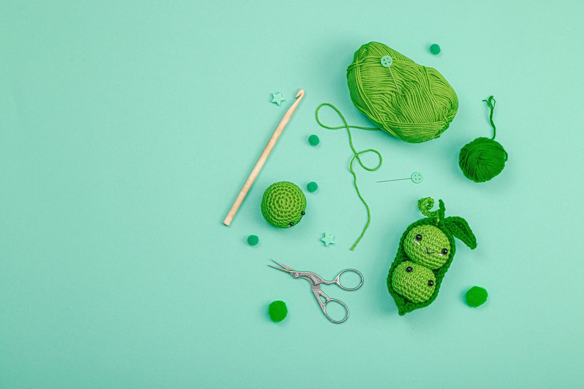 Materiales para amigurumi: lanas, aguja de crochet y accesorios sobre mesa